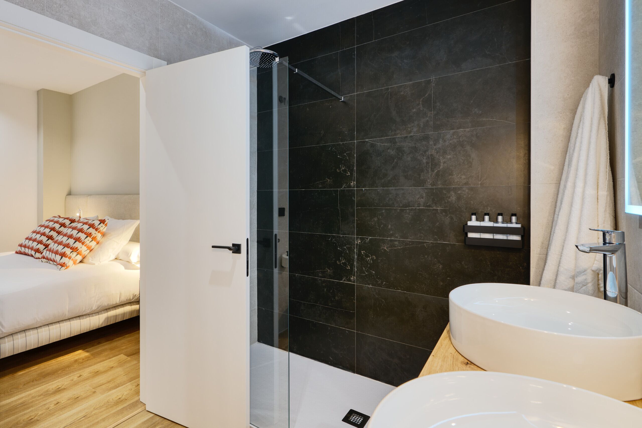 A modern bathroom with a large bathtub, a separate shower area, and a vanity with a sink.