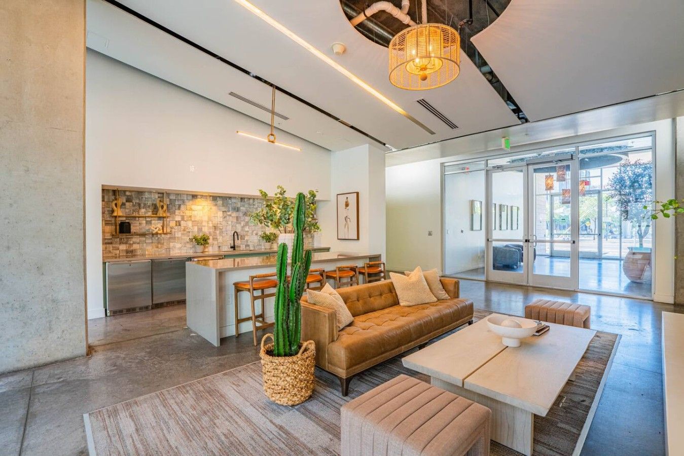 A modern living space with a kitchen, a sofa, and a dining area.
