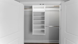 A walk-in closet with a built-in ladder shelf and a mirrored closet door. - Mountain Biking, Campus & close to downtown (Knoxville)