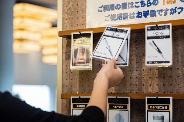 A hand holding a product package with a picture of a pen.