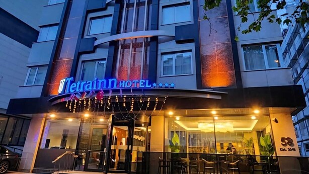 A modern hotel building with a prominent sign for 'Tetrann Hotel' and a staircase leading to the entrance. - Tetrainn Hotel (Ankara)