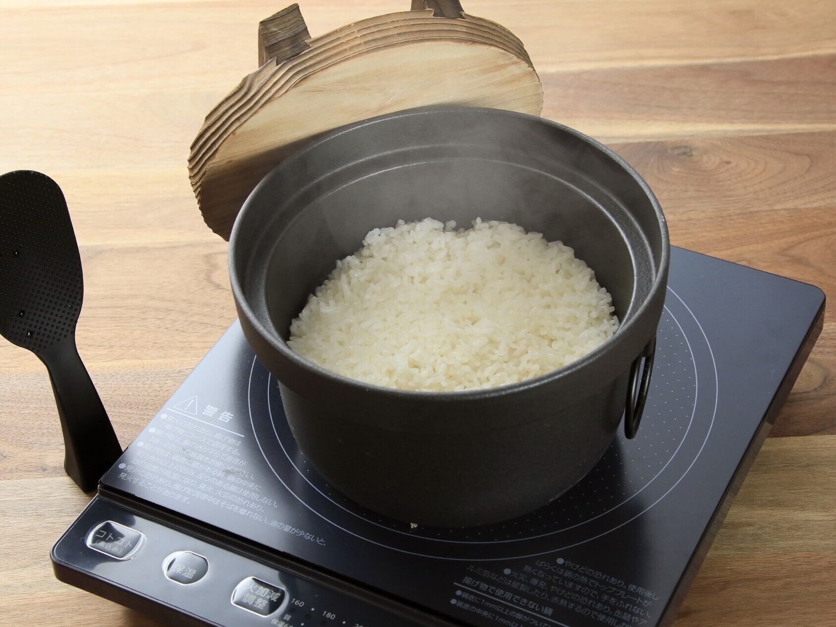 A pot of white rice on an induction cooktop.