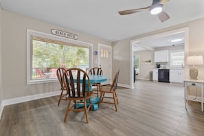 A dining area with a table and chairs, a ceiling fan, and a view of the beach through large windows. - *20% Off New Summer 2026 Bookings* (Murrells Inlet)