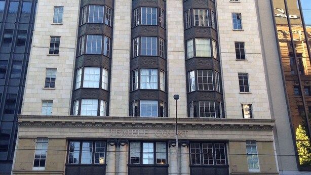 A multi-story building with a prominent entrance labeled "Temple Court."