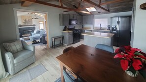A compact living space with a kitchen, dining area, and a living room. - Updated Lakefront cabin with AC & Queen Bed - 2 bedrooms plus sleeper sofa (Turtle Lake)