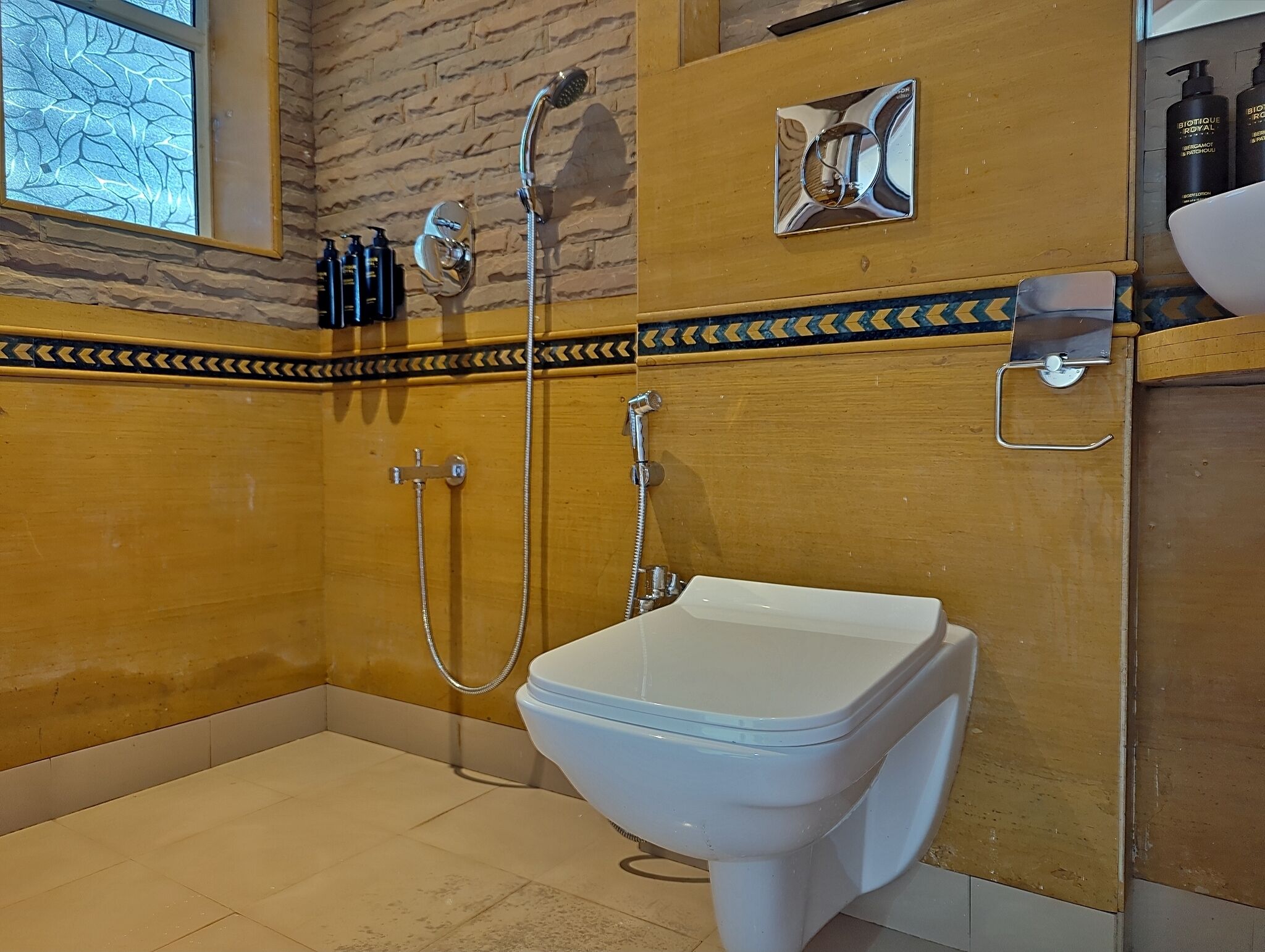 A bathroom with a shower, toilet, and a sink.
