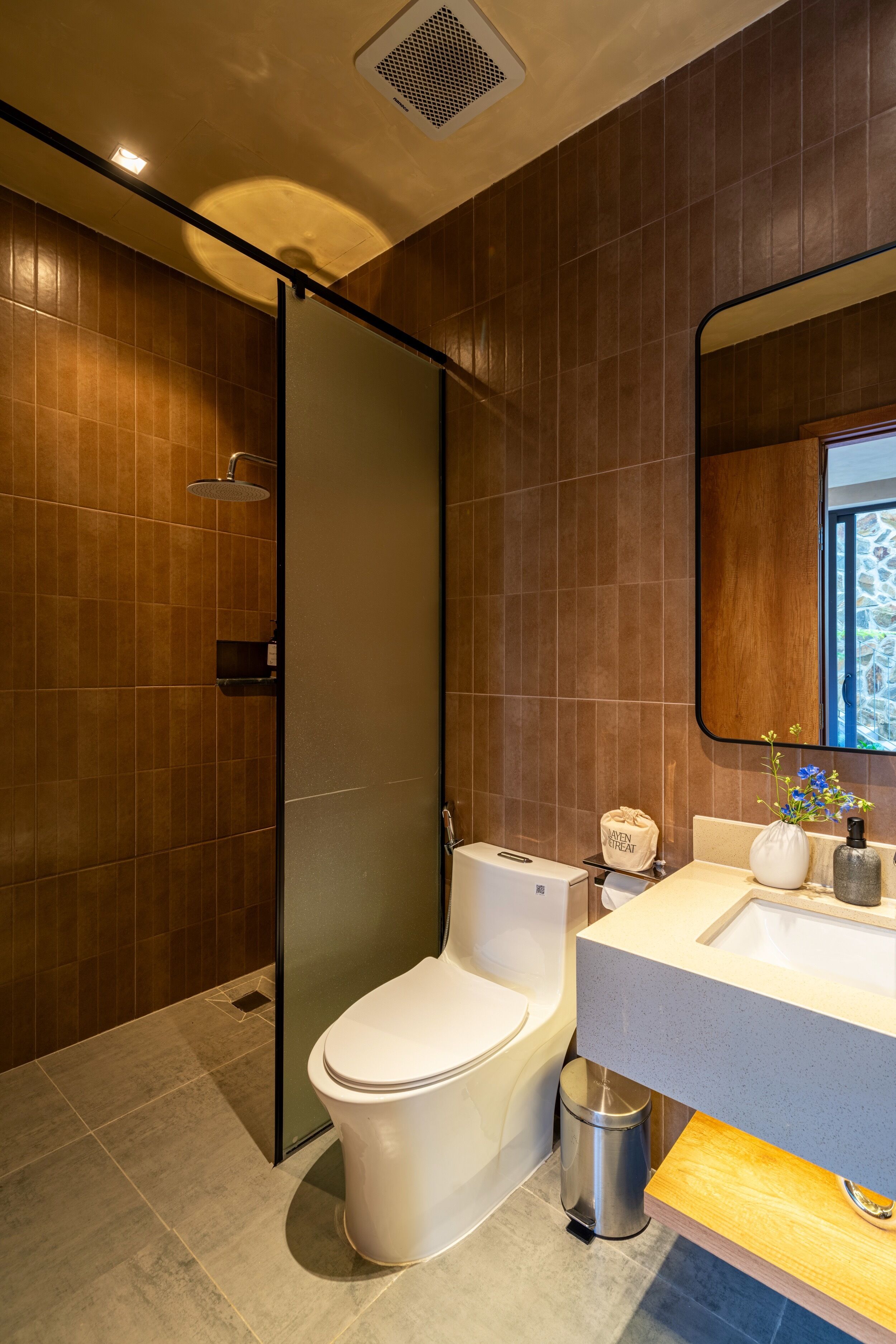 Une salle de bain moderne équipée d’une douche, de toilettes et d’un lavabo.
