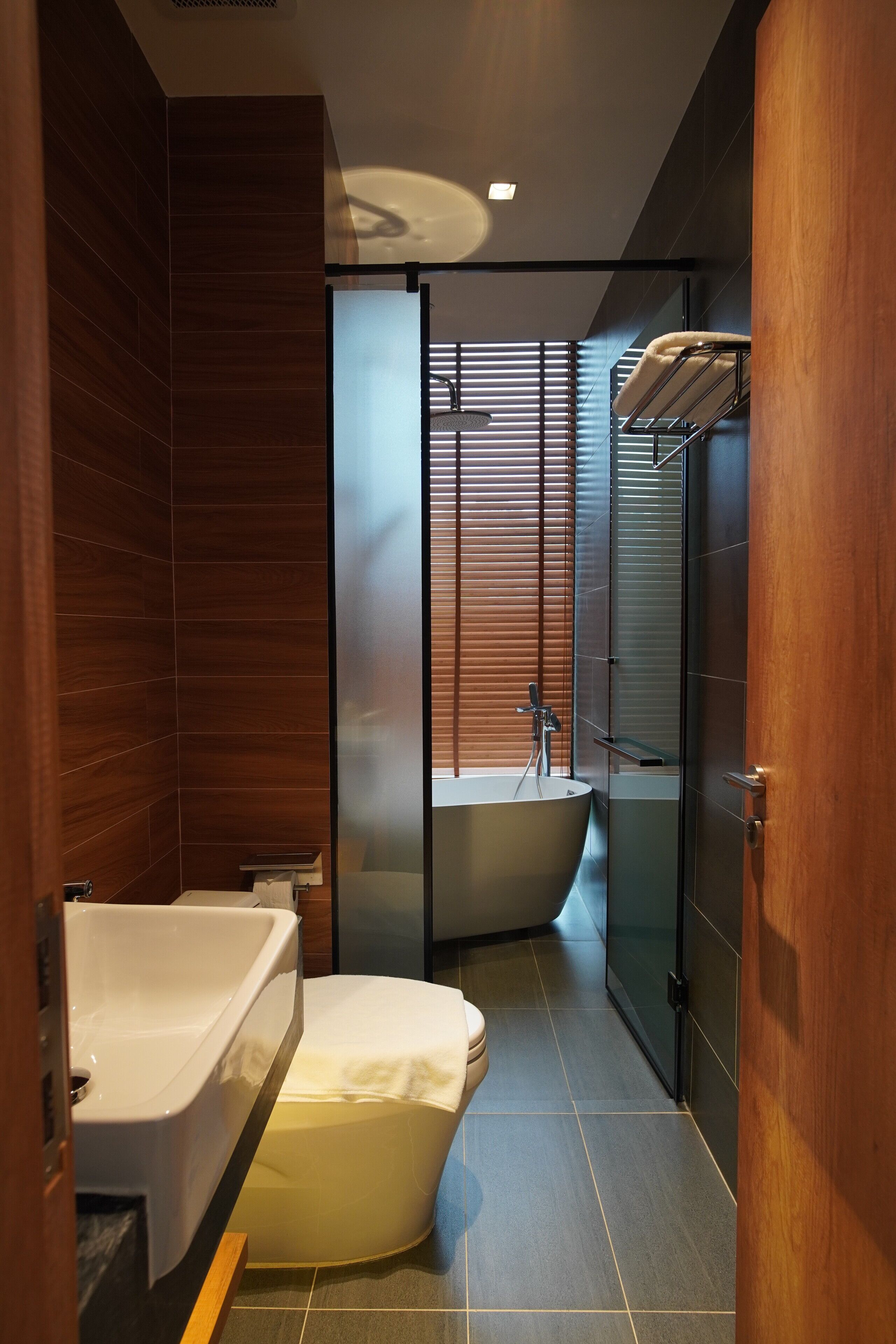 A modern bathroom with a freestanding bathtub, a shower enclosure, and a toilet.