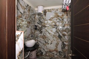 Ensemble baignoire-douche, articles de toilette (gratuits), pantoufles