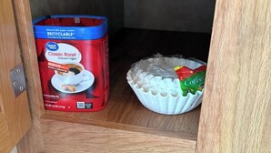 A storage area with a coffee maker and a bag of coffee pods. - Branson Glamping - all set up for you (Branson)