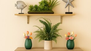 Une étagère en bois ornée d’une plante en pot, d’une sculpture de poisson décorative et d’un ornement en forme d’étoile de mer.