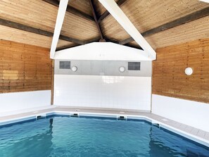 An indoor swimming pool with wooden walls and a sloped ceiling. - Apartment on Ile D'oleron Near the Beach (Saint-Georges-d'Oleron)