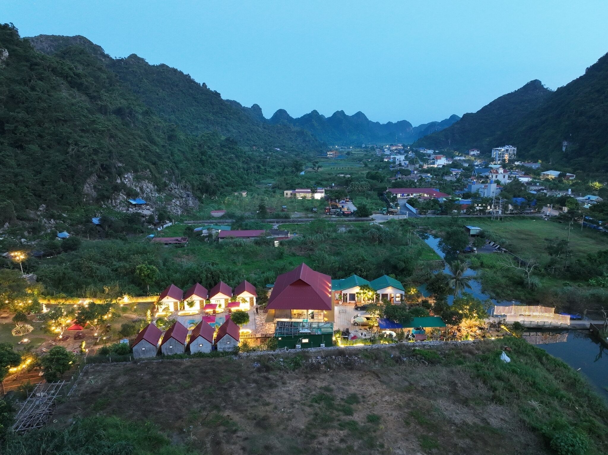 A rural village with houses and a river.