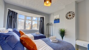 A hotel room with two beds, a bedside table, a clock, and a view of the outside. - 4 BedRoom House | w/ FREE Wi-fi | Parking (West Midlands)