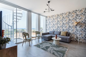 City view - 1BR Apartment (B3-1) | Living room | 50-inch Smart TV with digital channels, streaming services