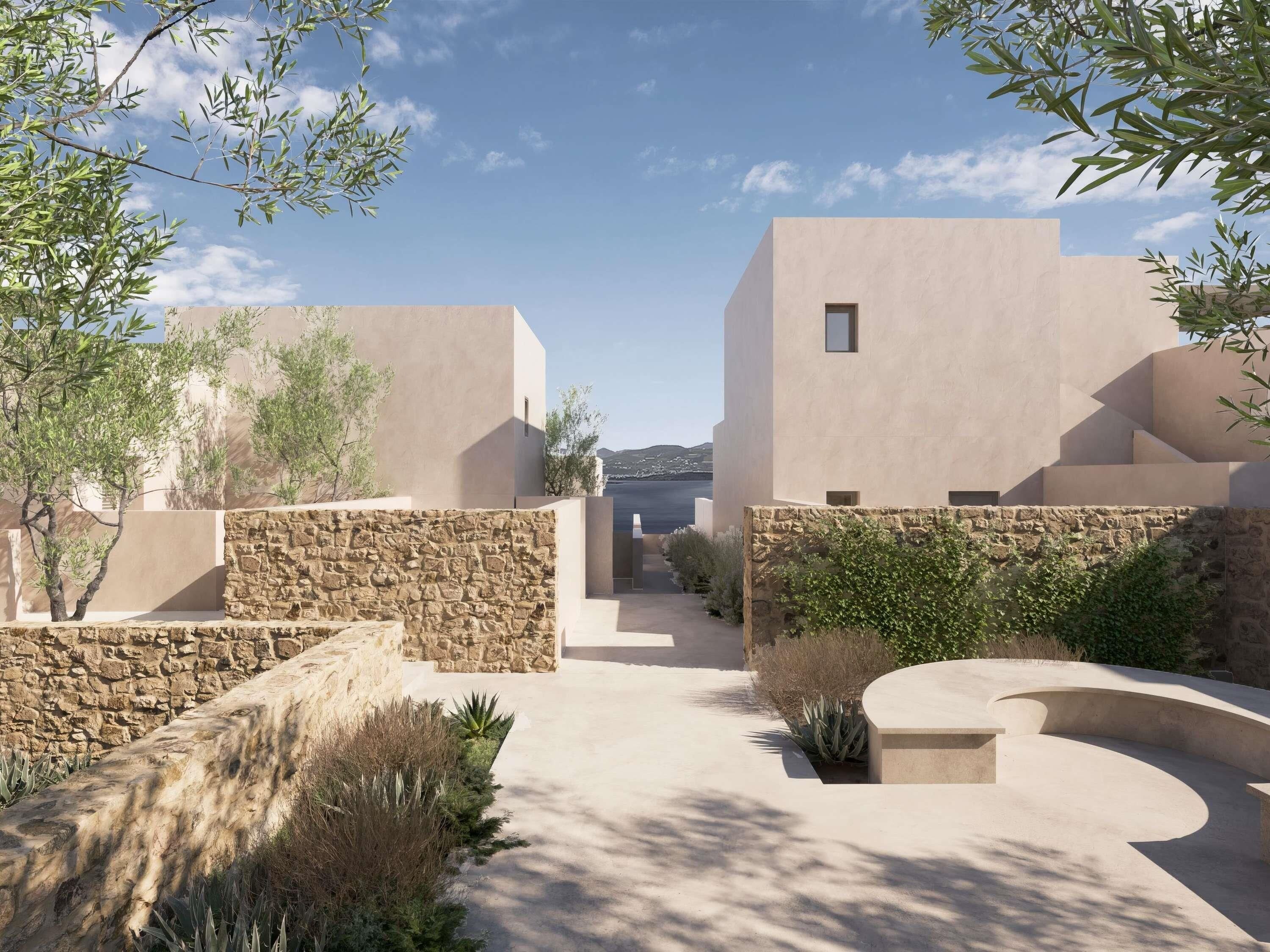 Un design architectural moderne, avec une cour intérieure, des murs en pierre et de la verdure.