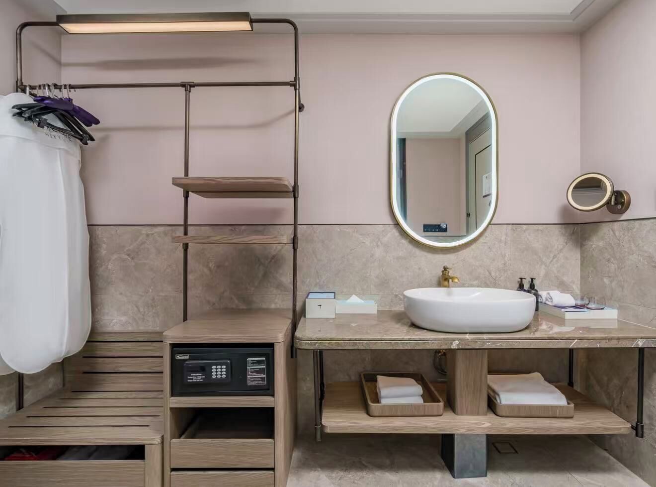 A modern bathroom with a built-in shower, a vanity with a sink, a mirror, and a towel rack.