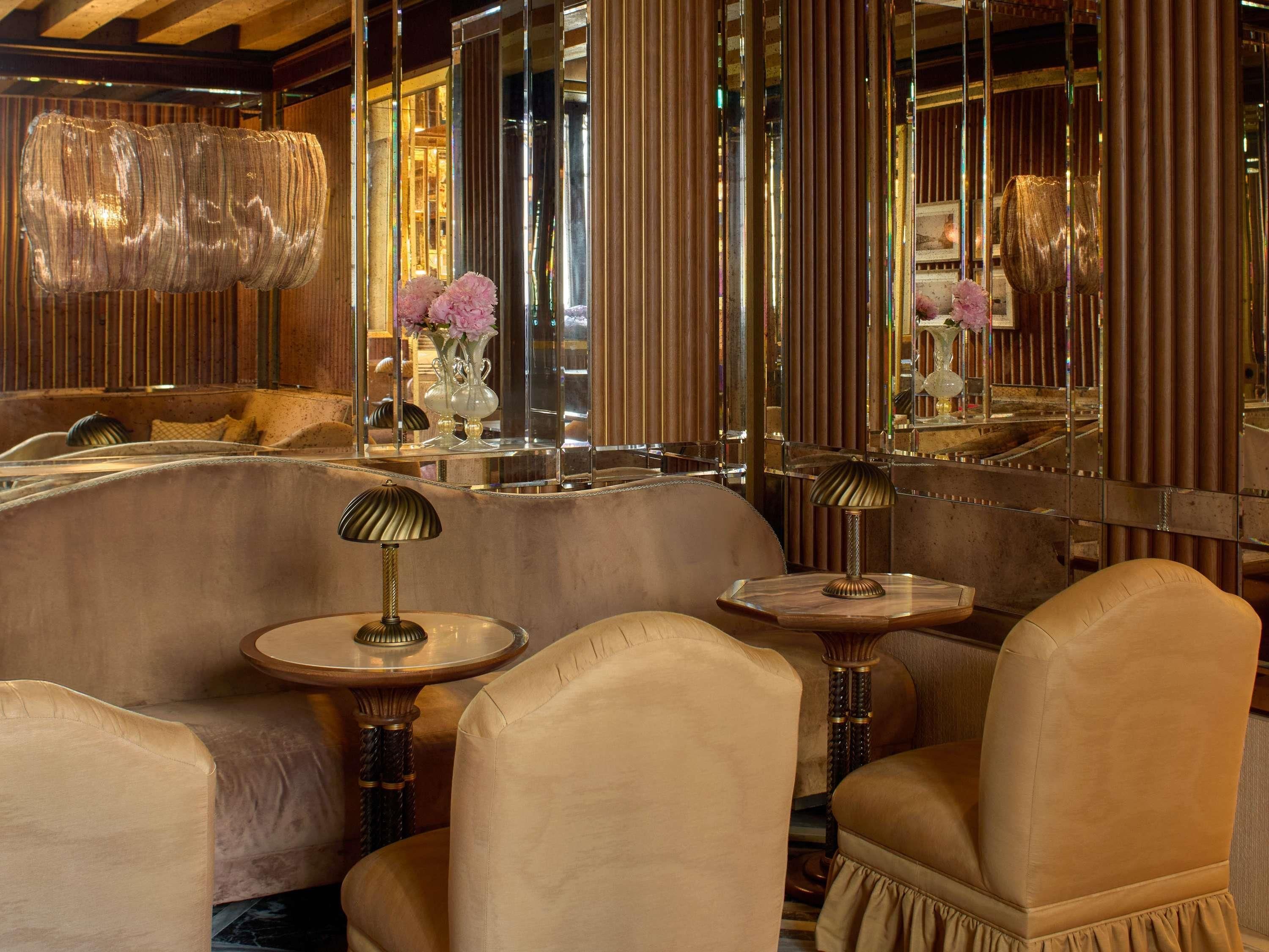 A luxurious interior with plush seating, reflective surfaces, and elegant decor.