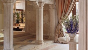 A grand hall with classical architecture, including columns and a high ceiling. - Orient Express Venezia (Venice)