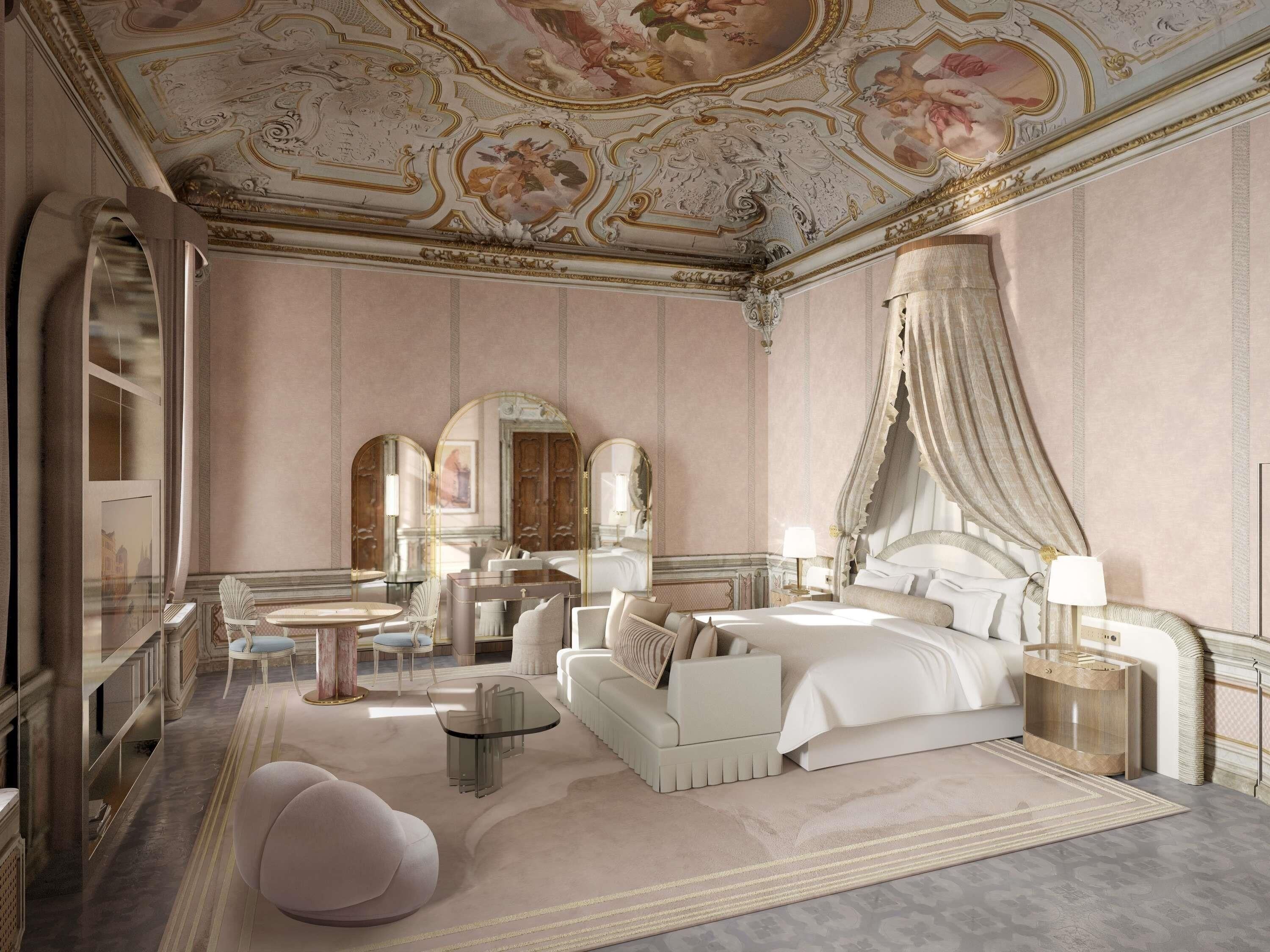 A luxurious bedroom with a canopy bed, a chaise lounge, a glass coffee table, and ornate ceiling artwork.