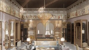 A luxurious interior with a grand chandelier, ornate ceiling, and classical artwork. - Orient Express Venezia (Venice)