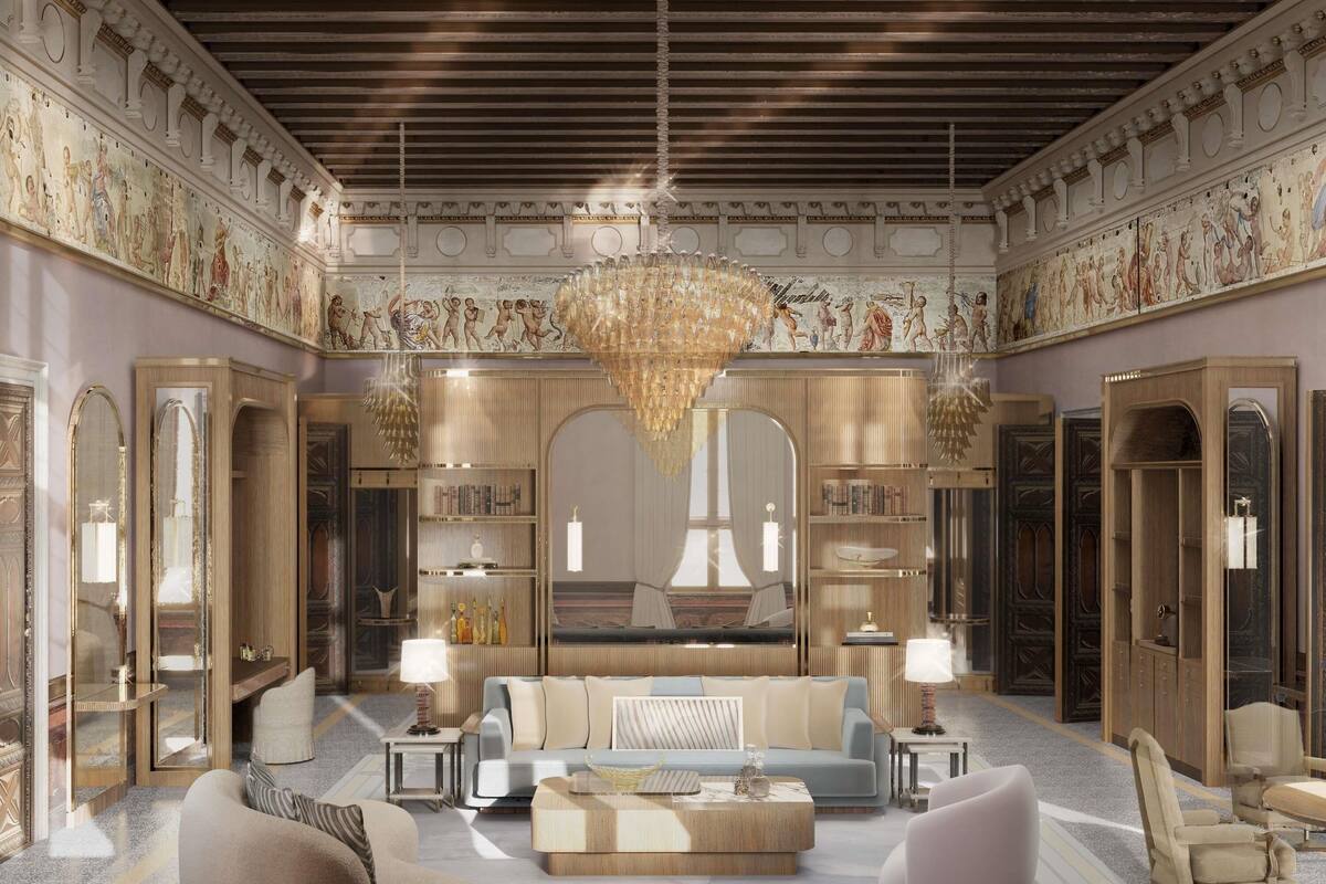 A luxurious interior with a grand chandelier, ornate ceiling, and classical artwork.