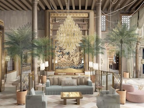 A luxurious lobby with a grand chandelier, a large ornate wall mural, and multiple seating areas. - Orient Express Venezia (Venice)