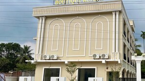 The exterior of Hatimurias Boutique Resort with a prominent sign, large windows, and a symmetrical facade. - Hatimurias Boutique Resort (Sonapur)