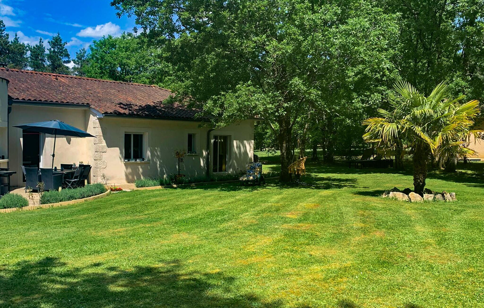 A house with a patio and a lawn.