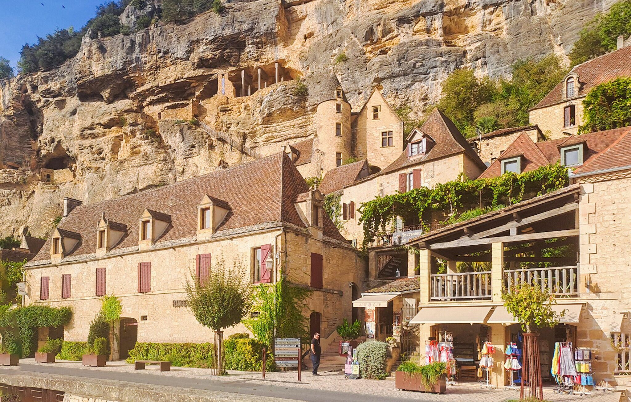 A stone building with a balcony and a sign that reads "ART DE CLUB".