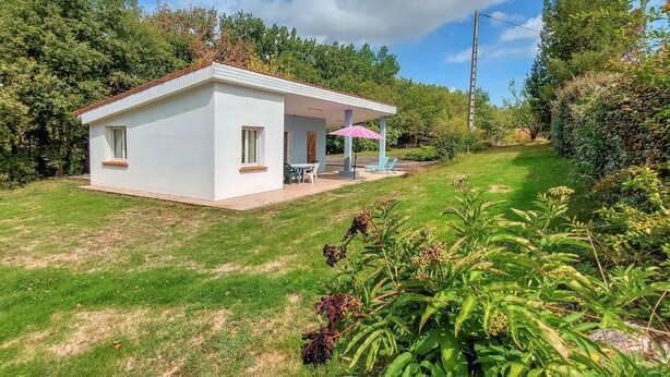 Una casa pequeña de un solo piso con un porche cubierto.