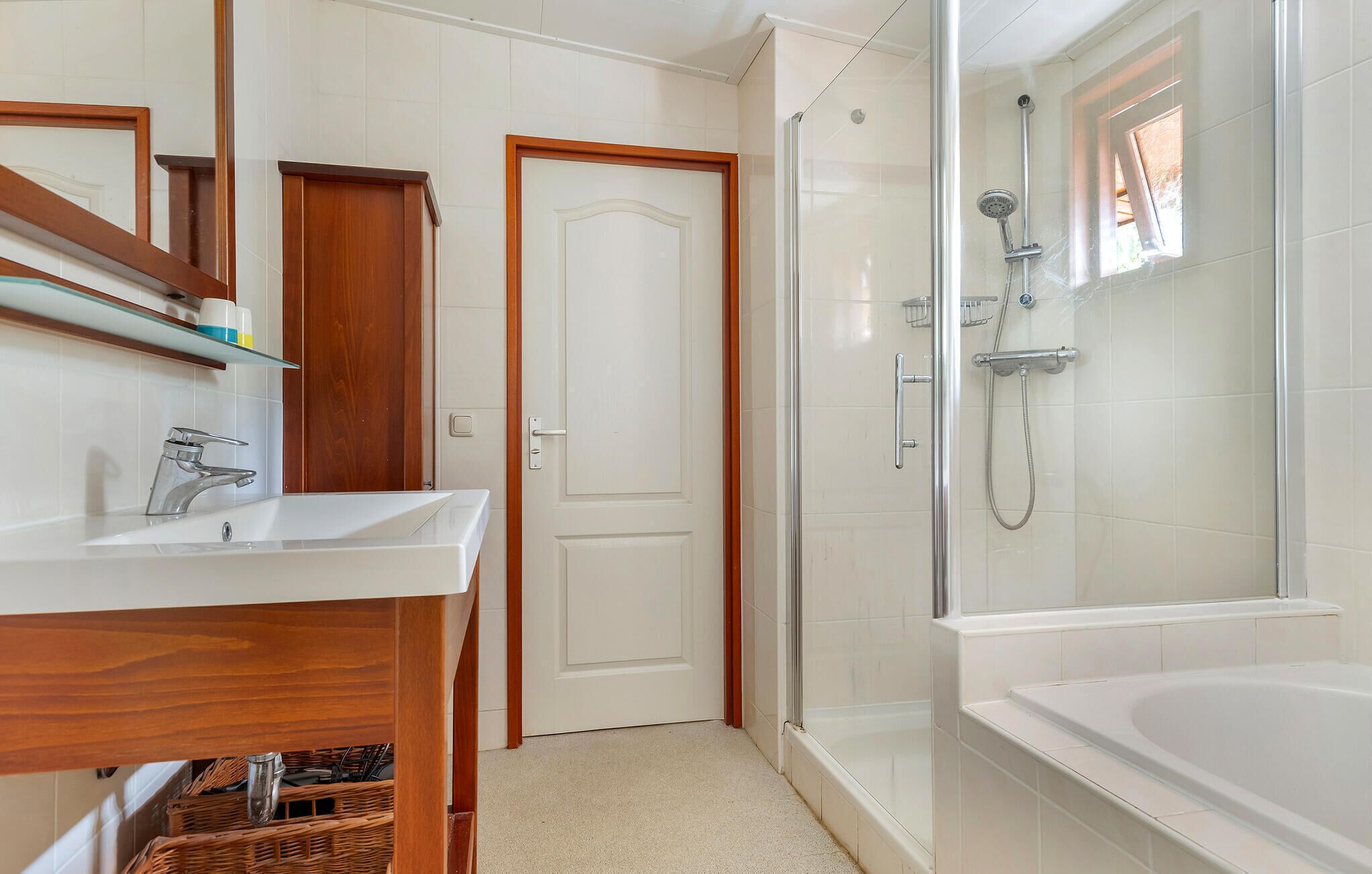 A bathroom with a shower, a bathtub, a sink, and a mirror.