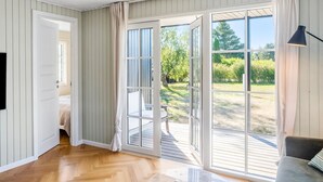 A room with a large sliding glass door leading to an outdoor deck.