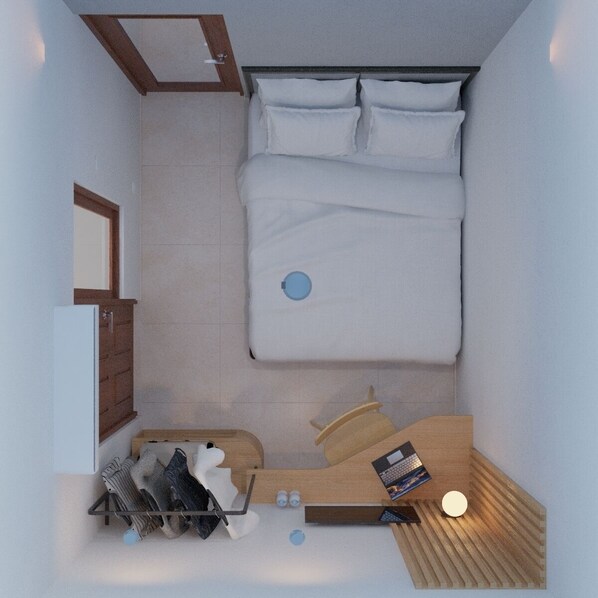 Una habitación pequeña con cama, un escritorio y un estante con zapatos y un libro.