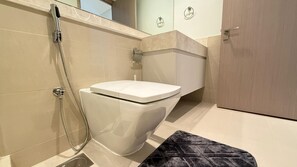 A modern bathroom with a toilet, shower, and a towel rack. - Premium 2bed Apartment In Downtown Act1 Tower (Dubai)