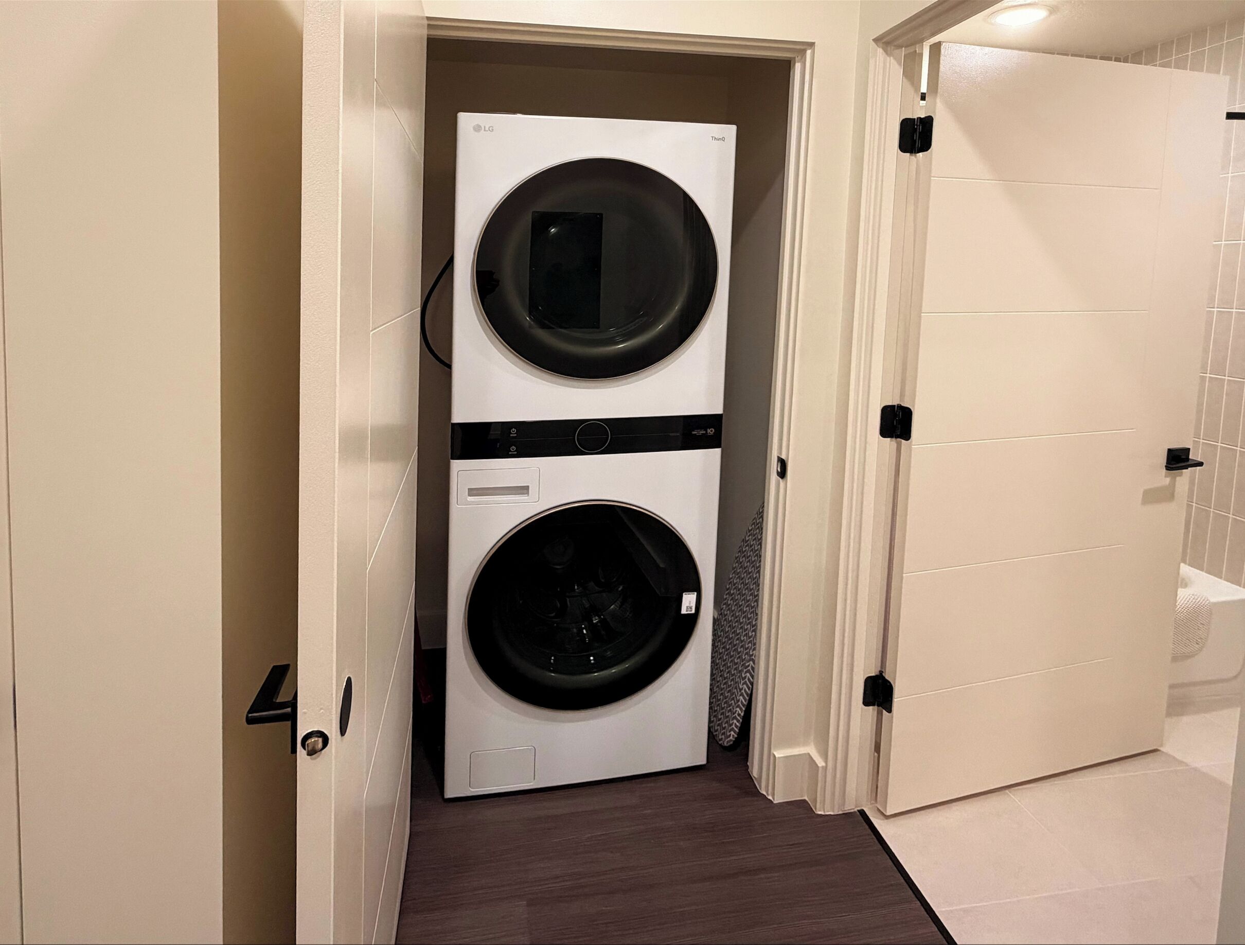 A laundry room with two stacked front-loading washing machines.