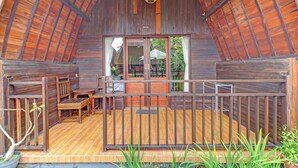 A wooden cabin with a balcony, wooden flooring, and a view of the surrounding area. - OYO 94782 Loka Loka Ubud (Ubud)