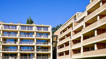 A multi-story hotel with balconies, large windows, and a central courtyard.