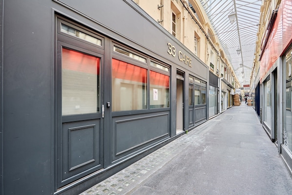 A corridor with storefronts, including a building labeled "33 CAFE".