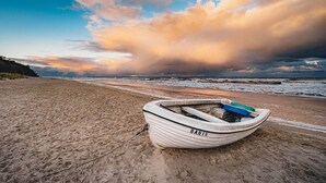 A boat named 'BANIN' on a sandy beach with a view of the ocean and a cloudy sky. - Quiet bungalow in Bansin with garden & WLAN - suitable for families & dogs (Seebad Bansin)