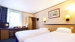 A hotel room with two beds, a desk with a computer, a chair, a TV, and a window with curtains. - The Galleon Hotel, Hull City, Part of the AG Collection (Hull)