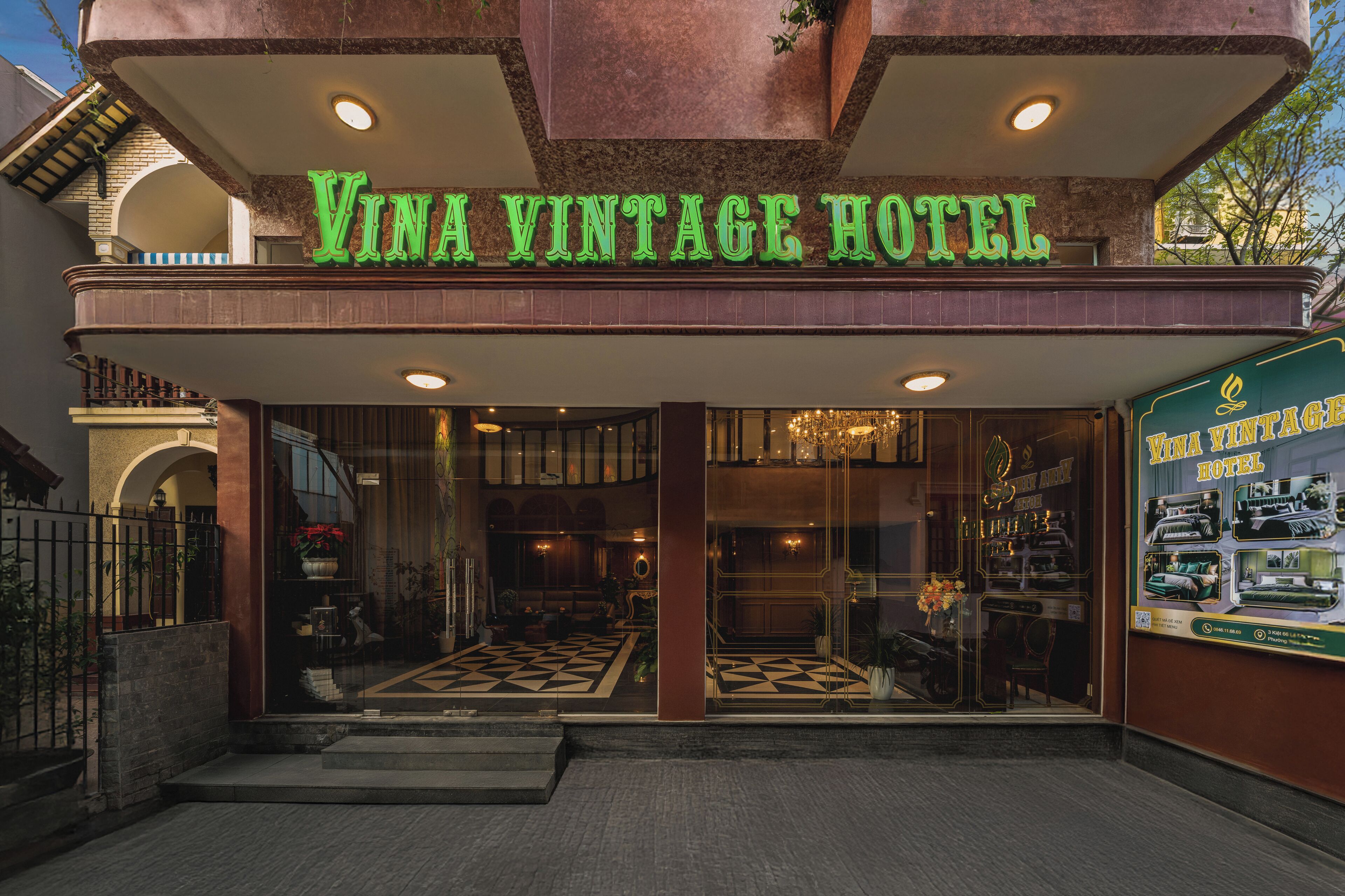 The exterior of the Vina Vintage Hotel with a classic design, featuring a marquee sign and a detailed entrance with a patterned floor.
