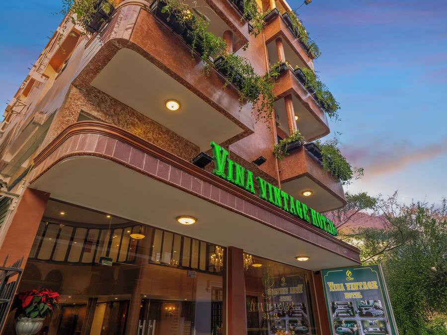 A multi-story building with a sign reading "Villa Vintage Hotel."