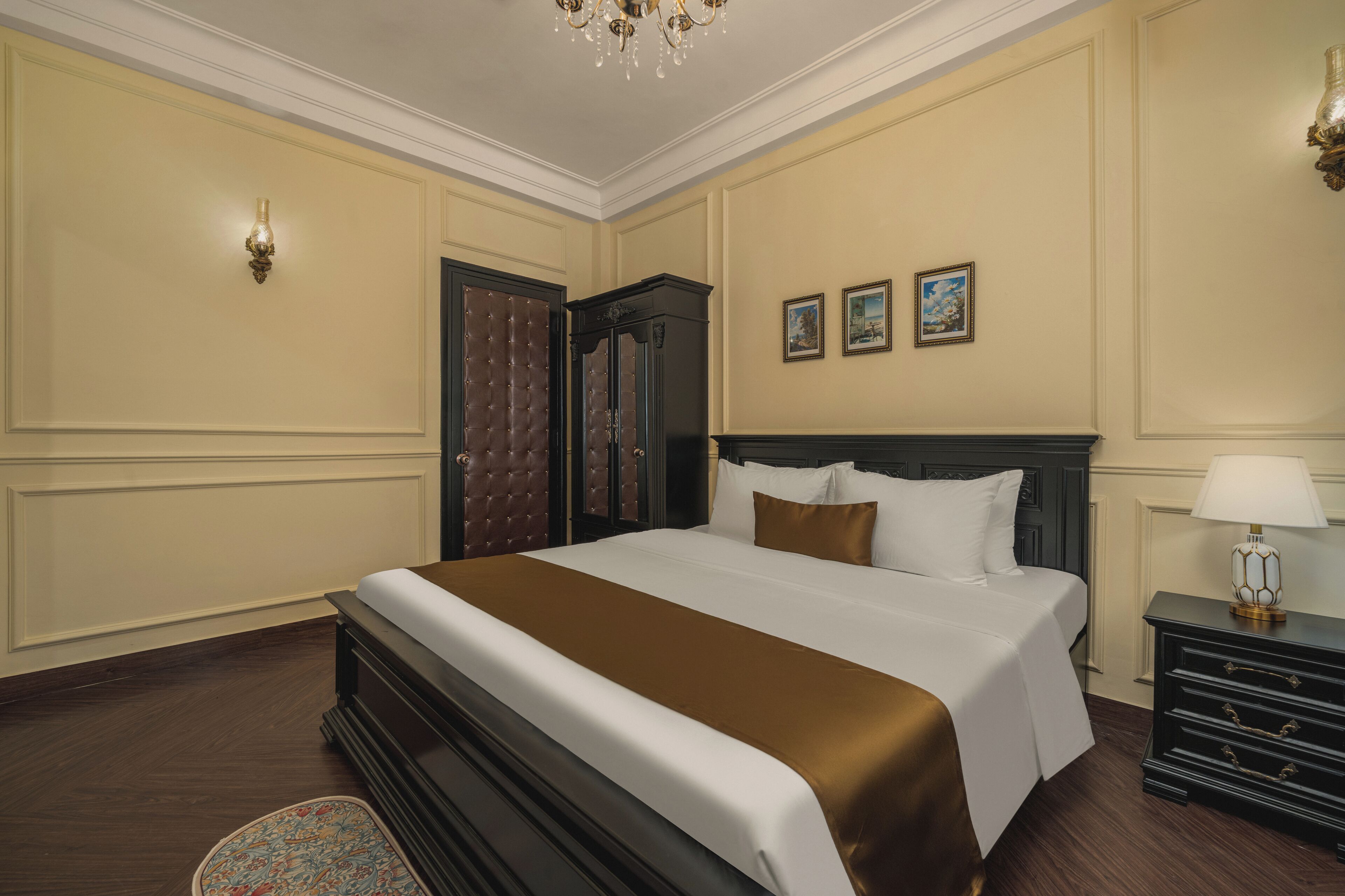 A neatly arranged bedroom with a large bed, a dresser, and a nightstand.
