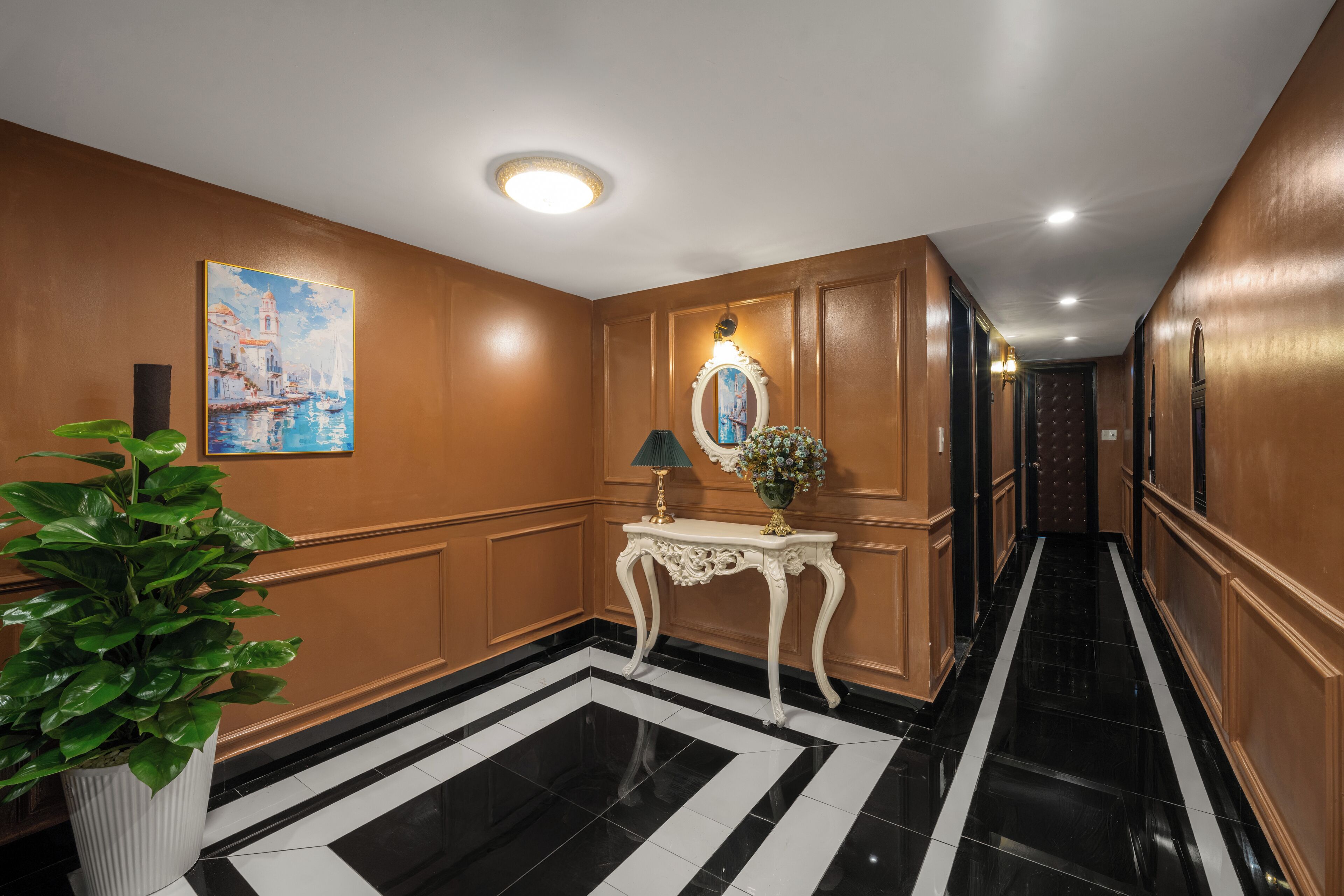A hallway with a black and white striped floor, a white console table with a mirror and lamp, and a large painting on the wall.