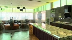 A modern kitchen with a marble countertop, a built-in oven, and a large window. - BaBa Boutique House Langkawi (Langkawi)
