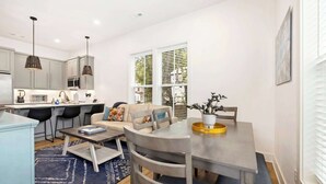 A compact living space with a kitchenette, dining area, and seating area.