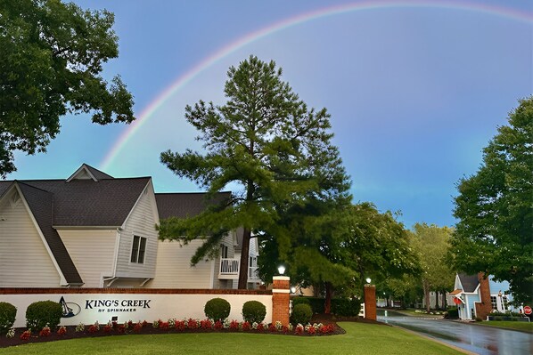 A residential area with a house labeled "King's Creek by Spinaker" and a large tree in the background.