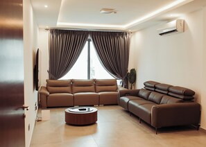 Living area - 2-bedroom corporate apartment in brilliant Accra with AC, fitness room (Accra)