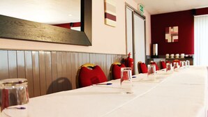 A conference room with a long table, red chairs, and glass water pitchers. - The Raceby Hotel, Doncaster (South Yorkshire), Part of the AG Collection (Doncaster)